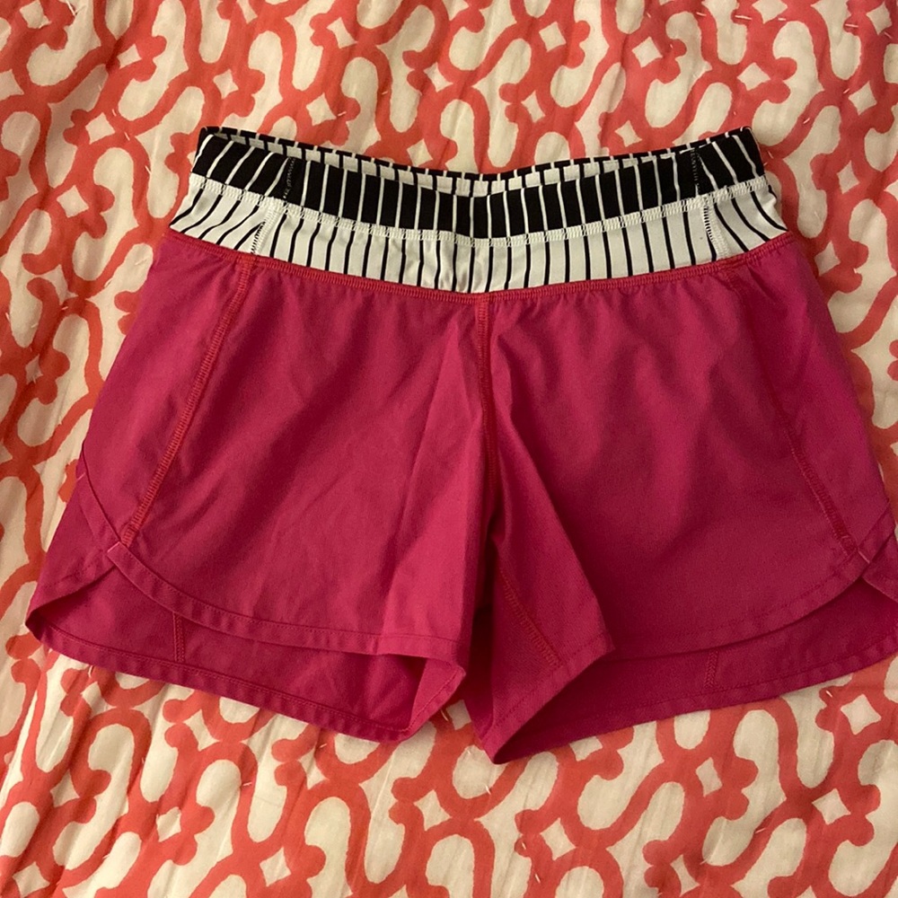 Ivivva hot pink shorts with black and white striped waistband